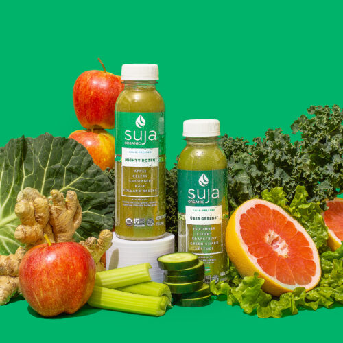 Suja bottles with spinach and other vegetables and fruit