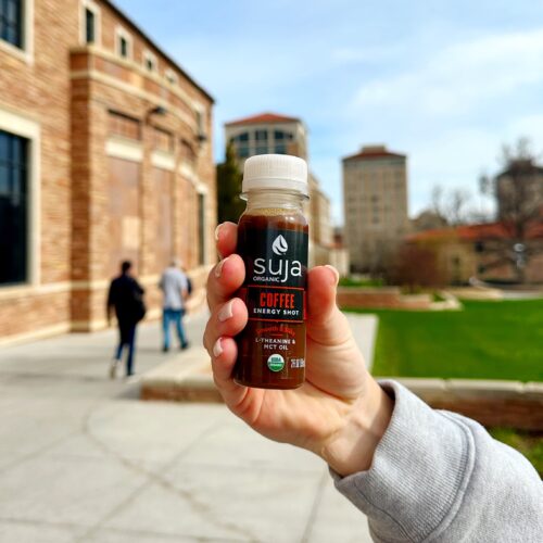 Suja Coffee shot in a hand